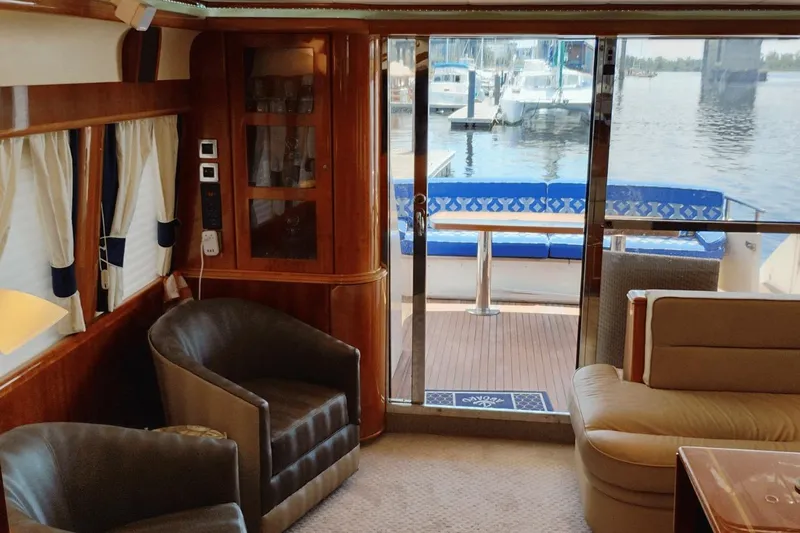  Yacht Photos Pics Luxurious 2001 Viking Princess 72 yacht interior with elegant seating and marina view.