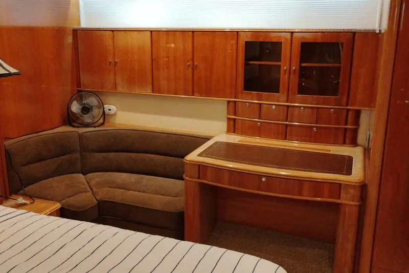  Yacht Photos Pics Luxurious wooden interior of a 2001 Viking Princess 72 yacht with cozy seating and cabinetry.