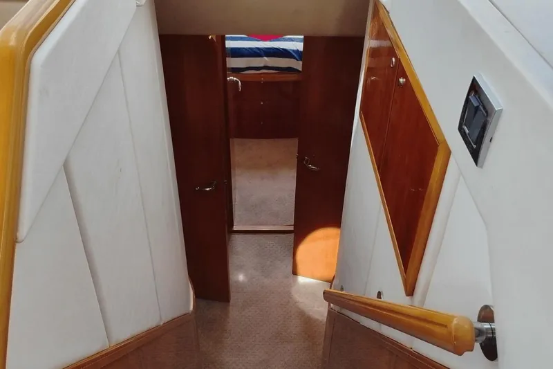  Yacht Photos Pics Stairway leading to cabin interior of 2001 Viking Princess 72 yacht.
