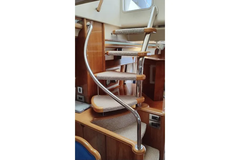  Yacht Photos Pics Spiral staircase inside 2001 Viking Princess 72 yacht with wooden and metal design.