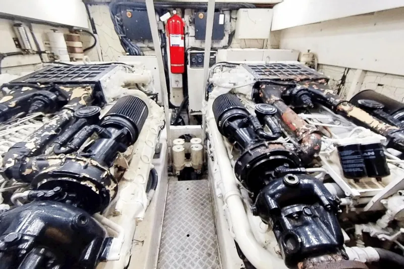  Yacht Photos Pics Engine room of 2001 Viking Princess 72 yacht, featuring dual engines and fire extinguisher.