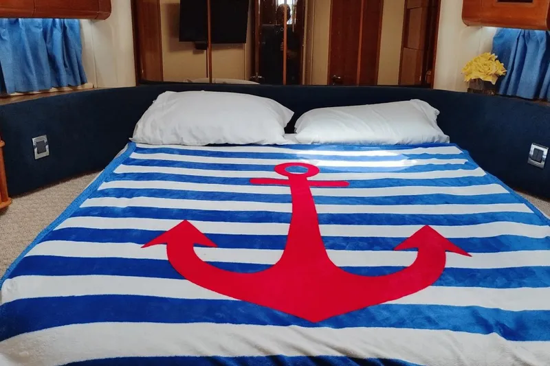 Yacht Photos Pics Nautical-themed bed in 2001 Viking Princess 72 yacht cabin with anchor blanket.