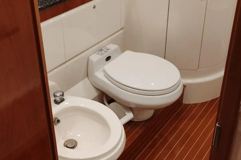  Yacht Photos Pics Bathroom interior of 2001 Viking Princess 72 yacht with toilet and sink.