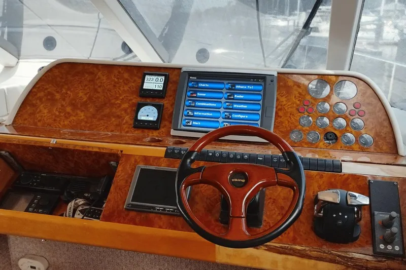  Yacht Photos Pics Cockpit of 2001 Viking Princess 72 yacht with wooden steering wheel and navigation controls.