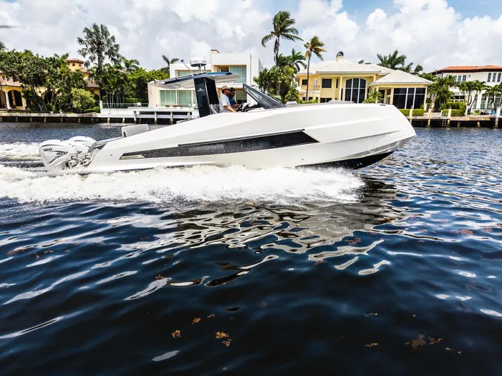 Sea-curitini Yacht Photos Pics 2024 Astondoa 377 yacht cruising on a sunny day near waterfront homes.