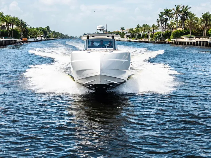 Sea-curitini Yacht Photos Pics 2024 Astondoa 377 yacht cruising on a scenic waterway with palm trees.