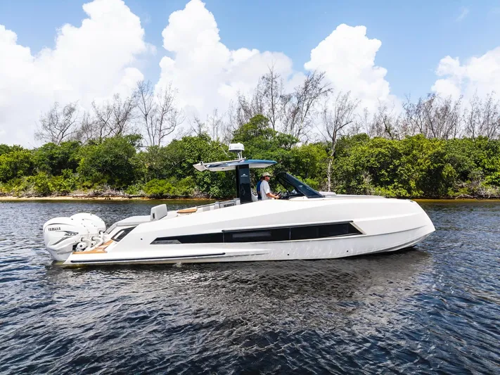 Sea-curitini Yacht Photos Pics 2024 Astondoa 377 yacht cruising on a calm river with lush greenery in the background.