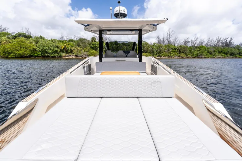 Sea-curitini Yacht Photos Pics 2024 Astondoa 377 yacht with luxurious white seating, cruising on a serene waterway.