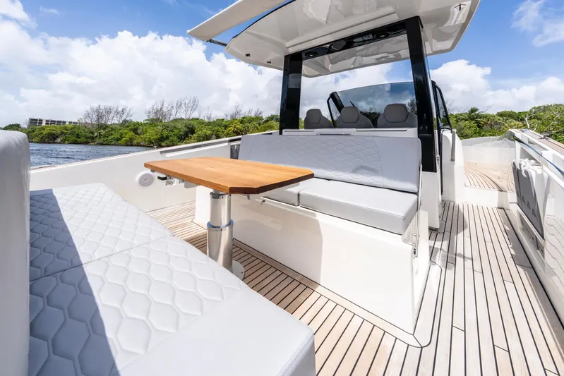 Sea-curitini Yacht Photos Pics 2024 Astondoa 377 yacht interior with sleek seating and wooden table on deck.
