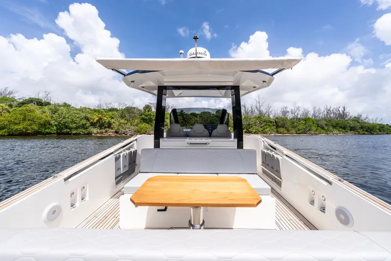 Sea-curitini Yacht Photos Pics 2024 Astondoa 377 yacht interior with seating and table, surrounded by water and greenery.