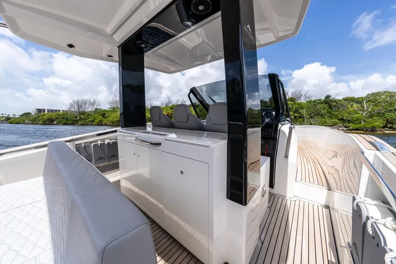 Sea-curitini Yacht Photos Pics 2024 Astondoa 377 yacht interior with sleek design and modern amenities, docked by lush greenery.