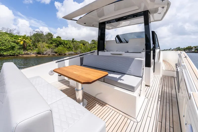 Sea-curitini Yacht Photos Pics 2024 Astondoa 377 yacht with elegant seating and wooden table on deck.