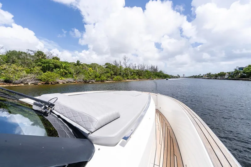Sea-curitini Yacht Photos Pics 2024 Astondoa 377 yacht cruising on a scenic river under a bright blue sky.