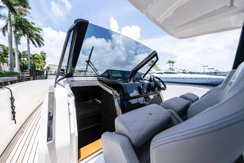 Sea-curitini Yacht Photos Pics 2024 Astondoa 377 yacht cockpit with modern controls and luxurious seating.