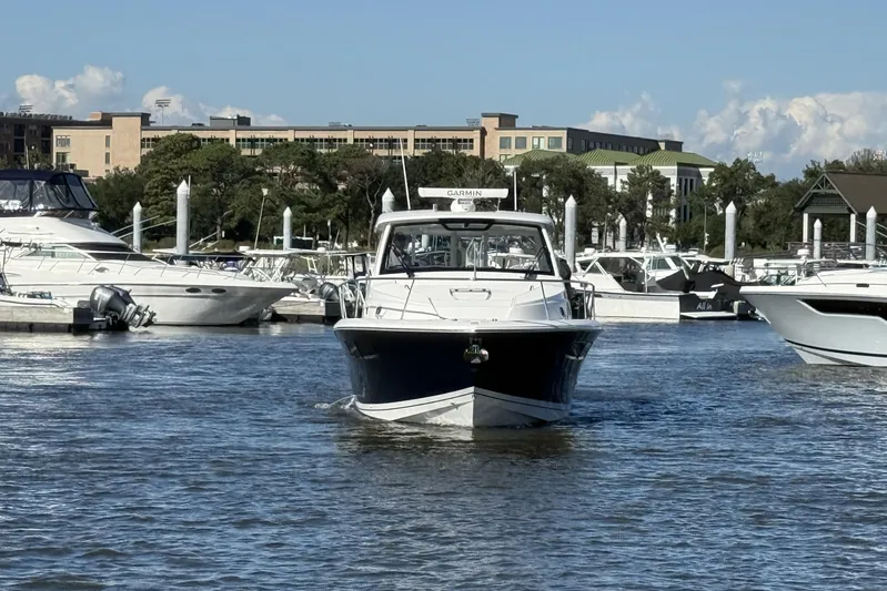 Seaquel Yacht Photos Pics 2026 Pursuit OS 355 Offshore boat navigating marina waters.