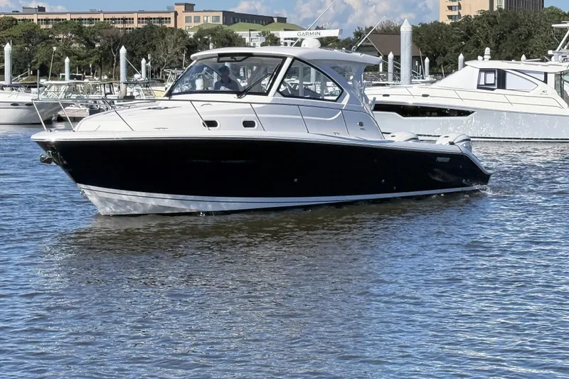 Seaquel Yacht Photos Pics 2026 Pursuit OS 355 Offshore boat cruising in a marina with other yachts.