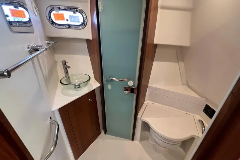 Seaquel Yacht Photos Pics 2026 Pursuit OS 355 Offshore bathroom with glass sink and modern fixtures.