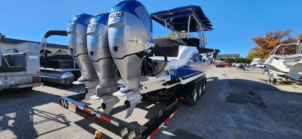 2017 Nor-Tech 390 Center Console boat with triple outboard engines on a trailer.