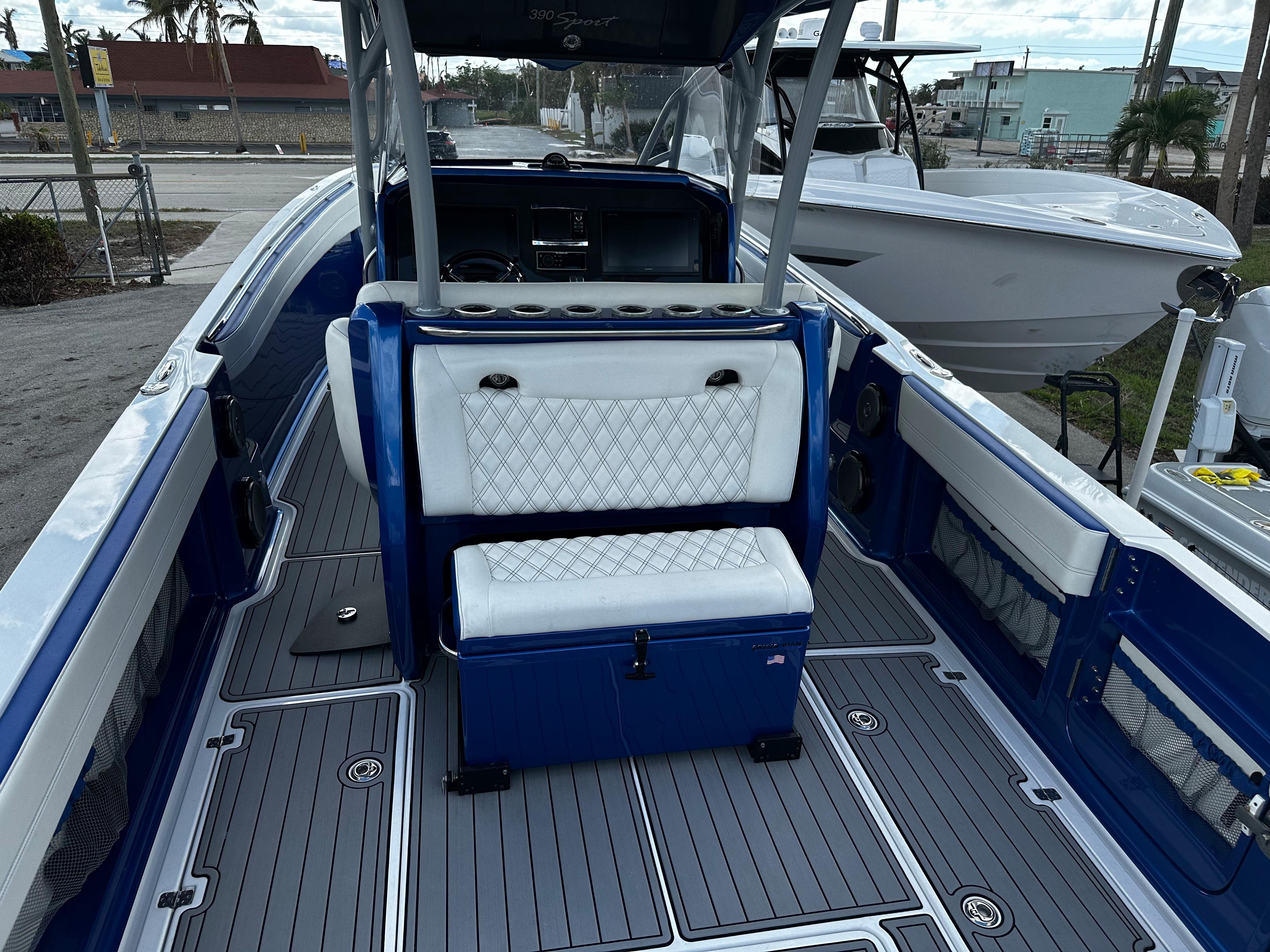 2017 Nor-Tech 390 Center Console boat with blue and white seating, docked outdoors.