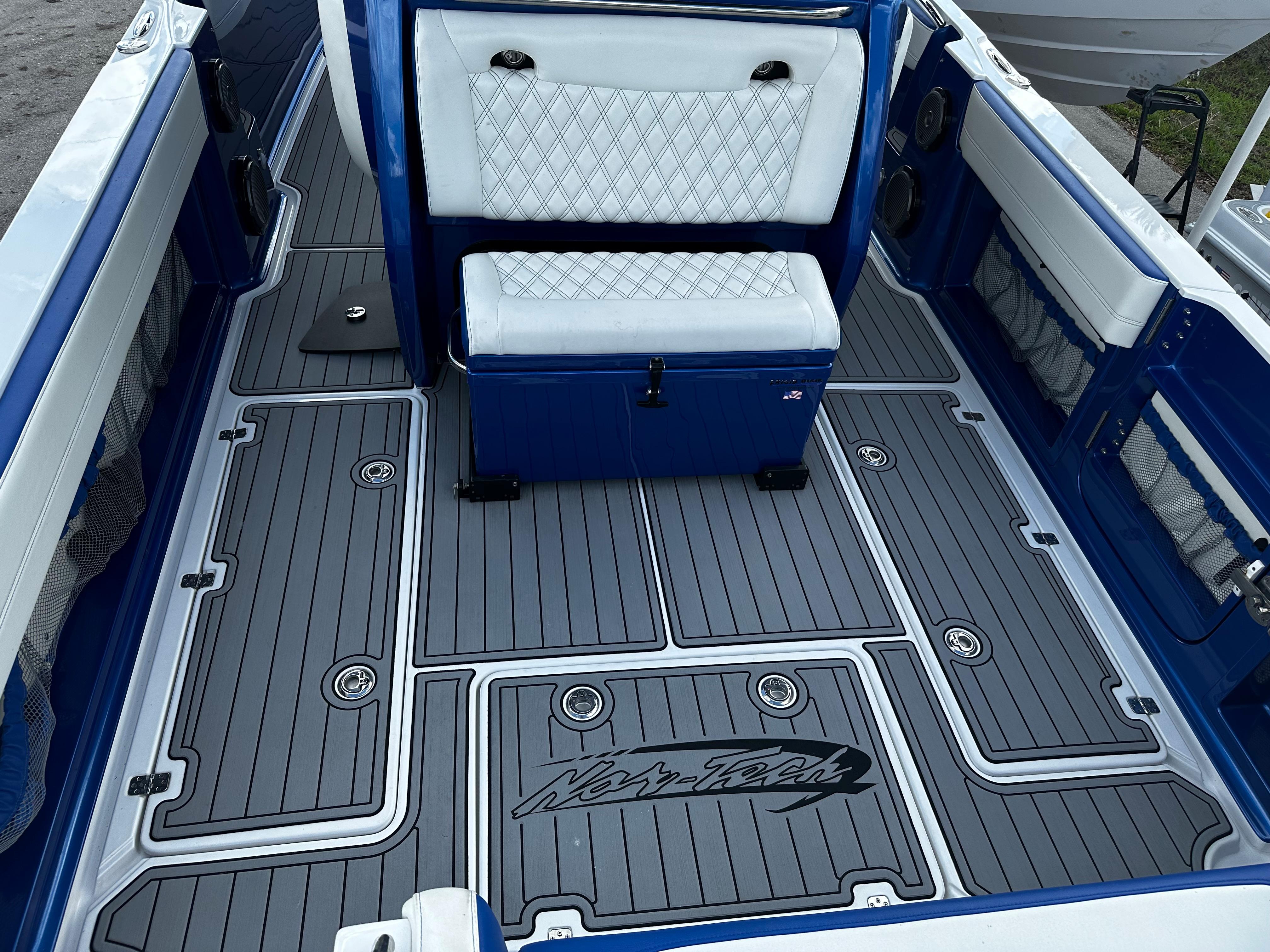 2017 Nor-Tech 390 Center Console boat interior with blue and white seating and custom flooring.