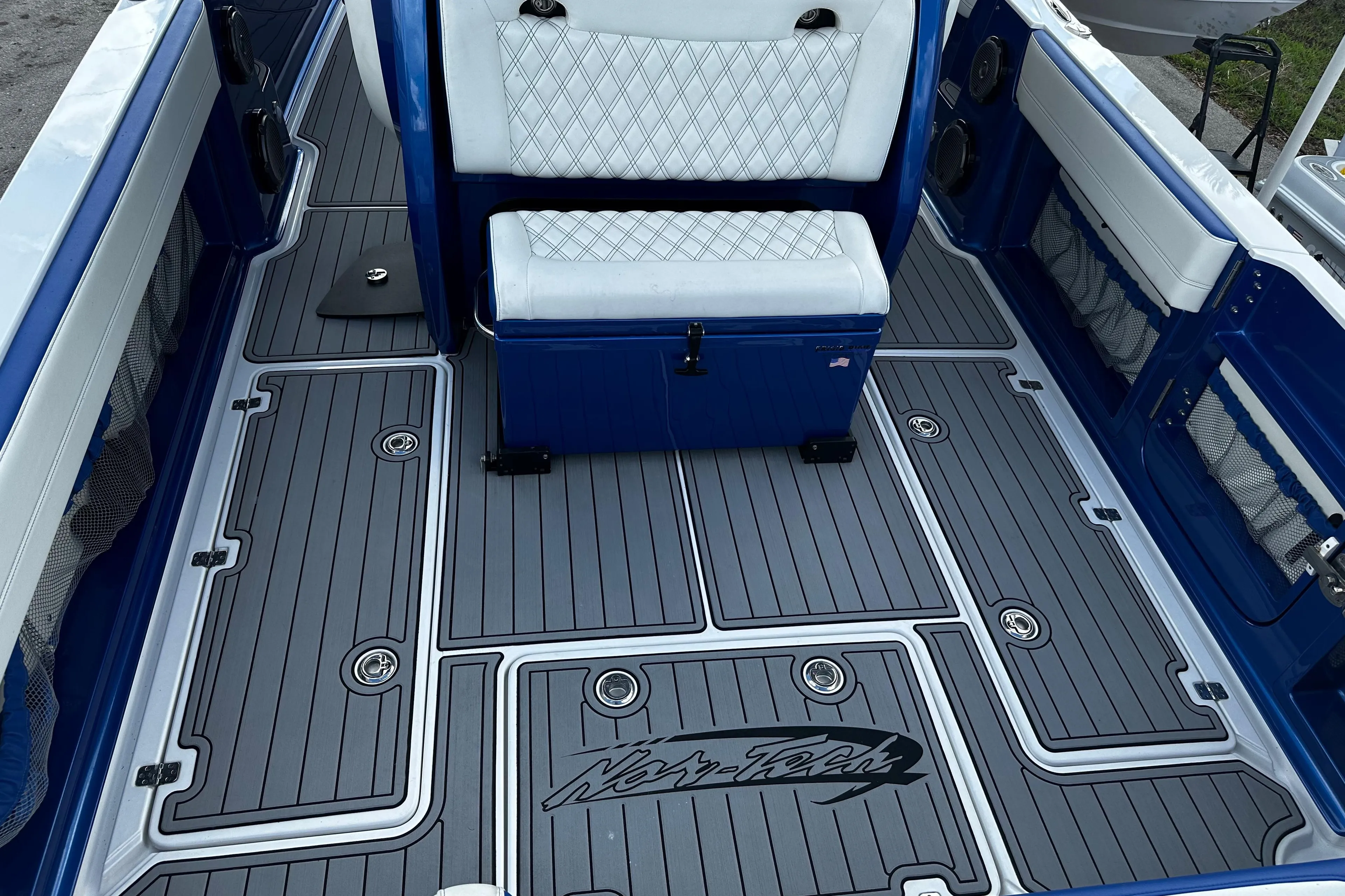 2017 Nor-Tech 390 Center Console boat interior with blue and white seating and custom flooring.