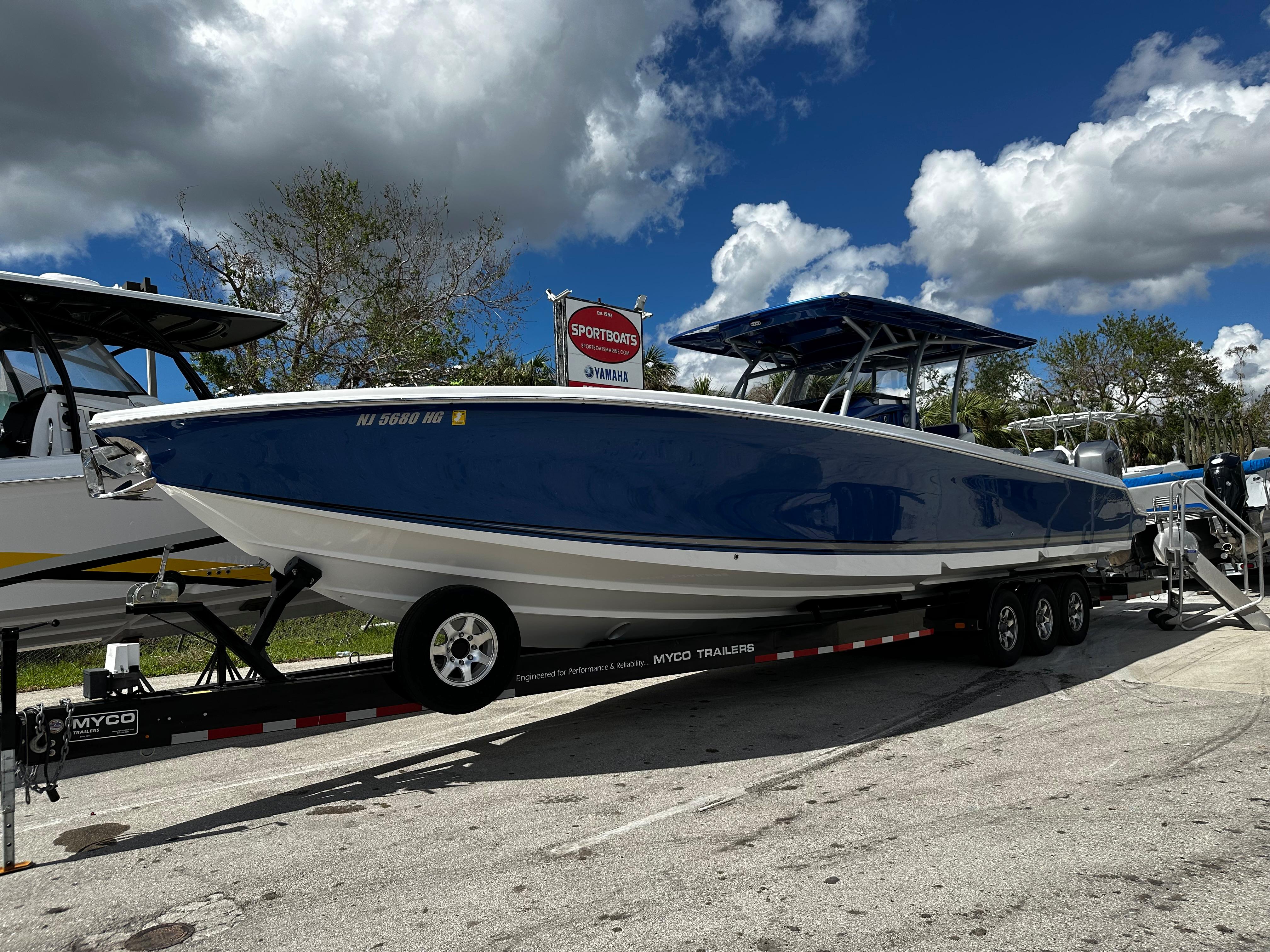 2017 Nor-Tech 390 Center Console boat on trailer under cloudy sky.