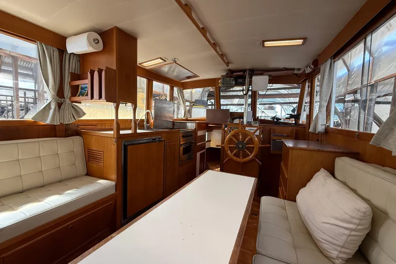 Badger Yacht Photos Pics Interior of 1980 Grand Banks 36 Classic yacht with wooden furnishings and helm station.