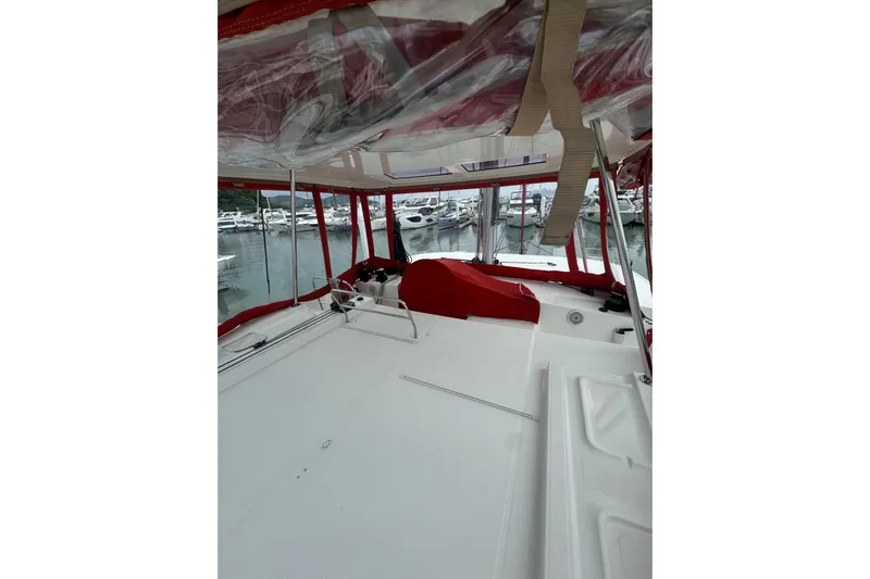 Cc Princess Yacht Photos Pics 2020 Lagoon 46 catamaran with red canopy, docked in marina.