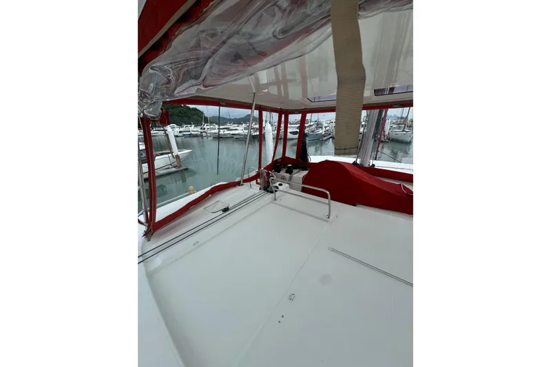 Cc Princess Yacht Photos Pics 2020 Lagoon 46 catamaran with red canopy, docked in a marina.