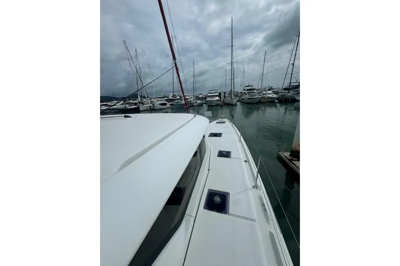 Cc Princess Yacht Photos Pics 2020 Lagoon 46 catamaran docked in a marina under cloudy skies.