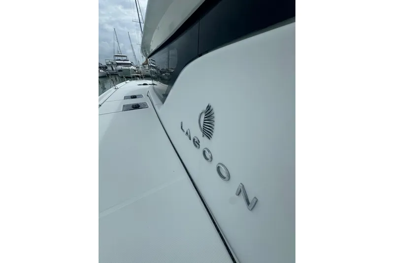 Cc Princess Yacht Photos Pics 2020 Lagoon 46 catamaran docked at marina, showcasing sleek design and branding.