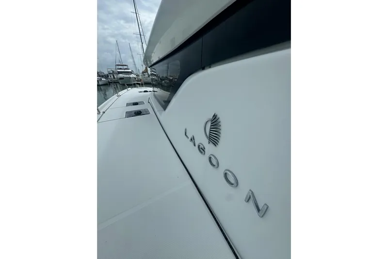 Cc Princess Yacht Photos Pics 2020 Lagoon 46 catamaran docked at marina, showcasing sleek design and logo.