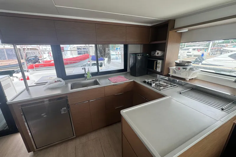 Cc Princess Yacht Photos Pics Modern kitchen interior of 2020 Lagoon 46 yacht with sleek cabinetry and appliances.