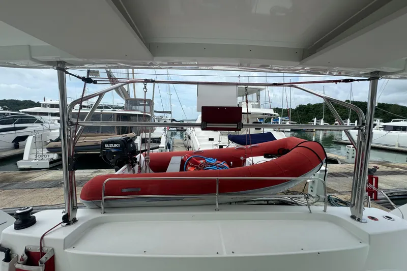 Cc Princess Yacht Photos Pics 2020 Lagoon 46 catamaran with red inflatable boat and Suzuki motor at marina.