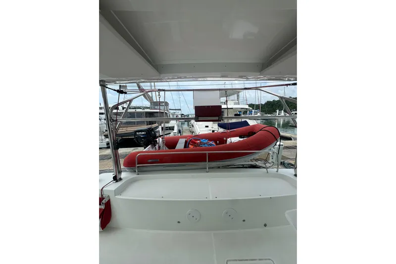 Cc Princess Yacht Photos Pics 2020 Lagoon 46 catamaran with red inflatable boat and Suzuki motor at marina.