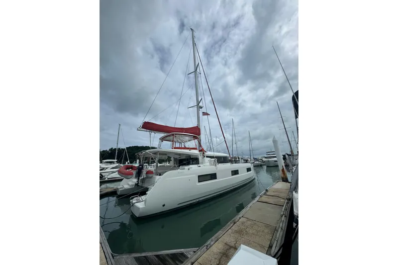 Cc Princess Yacht Photos Pics 2020 Lagoon 46 catamaran docked at marina under cloudy sky.