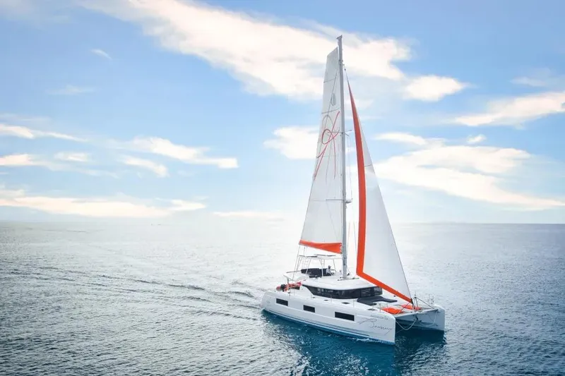 Cc Princess Yacht Photos Pics 2020 Lagoon 46 catamaran sailing on open sea under clear blue sky.