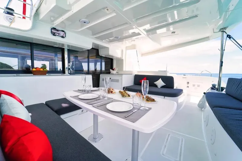 Cc Princess Yacht Photos Pics Interior of 2020 Lagoon 46 catamaran with elegant dining setup and ocean view.
