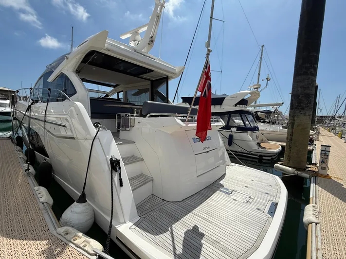 Boo Boo Yacht Photos Pics 2020 Sunseeker Predator 50 yacht docked at marina under clear blue sky.