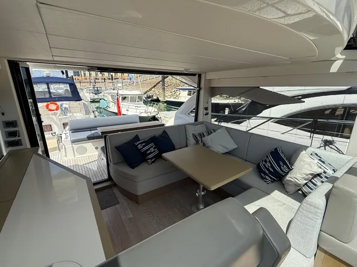 Boo Boo Yacht Photos Pics Luxurious interior of 2020 Sunseeker Predator 50 yacht with elegant seating and marina view.