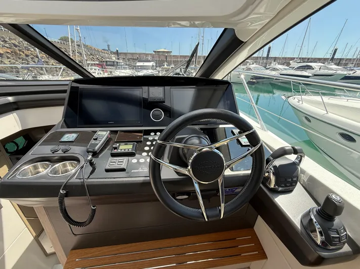 Boo Boo Yacht Photos Pics Sunseeker Predator 50 yacht helm, 2020 model, featuring advanced navigation controls and steering wheel.