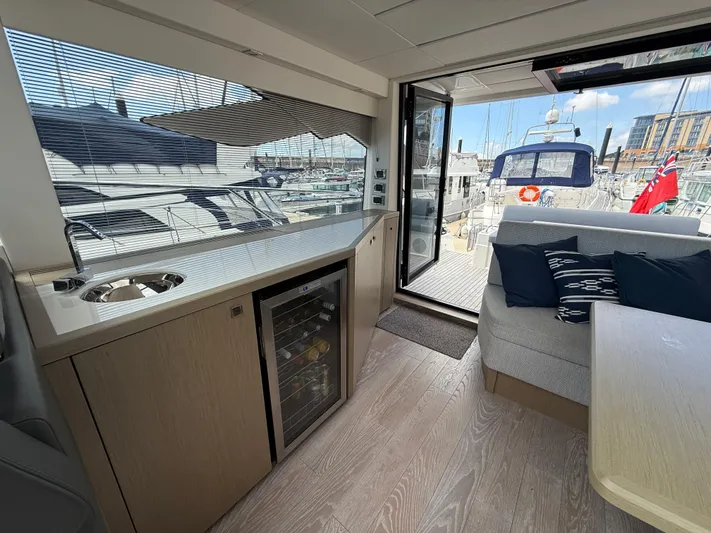 Boo Boo Yacht Photos Pics Luxurious interior of 2020 Sunseeker Predator 50 yacht with kitchenette and seating area.