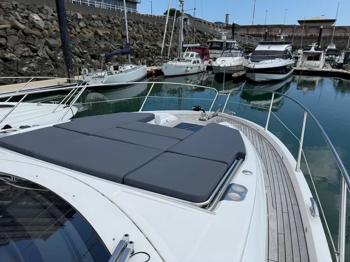 Boo Boo Yacht Photos Pics Sunseeker Predator 50 yacht, 2020 model, docked in marina with sunbathing area.
