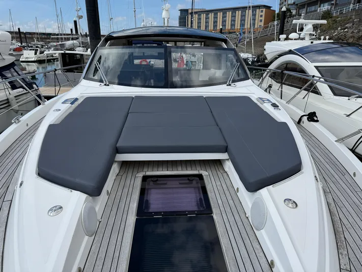 Boo Boo Yacht Photos Pics 2020 Sunseeker Predator 50 yacht with sleek deck and luxurious seating in marina.