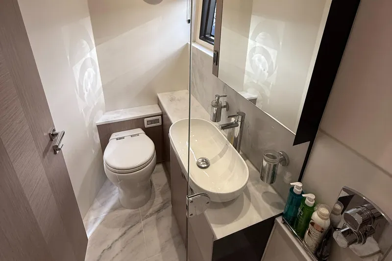 Boo Boo Yacht Photos Pics Luxurious bathroom in 2020 Sunseeker Predator 50 yacht, featuring modern fixtures and elegant design.