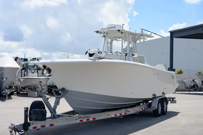 Seavee Yacht Photos Pics 2021 SeaVee 322Z boat on trailer, parked outdoors under a cloudy sky.