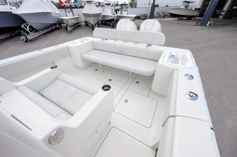 Seavee Yacht Photos Pics 2021 SeaVee 322Z boat interior with white seating and cup holders in a showroom.