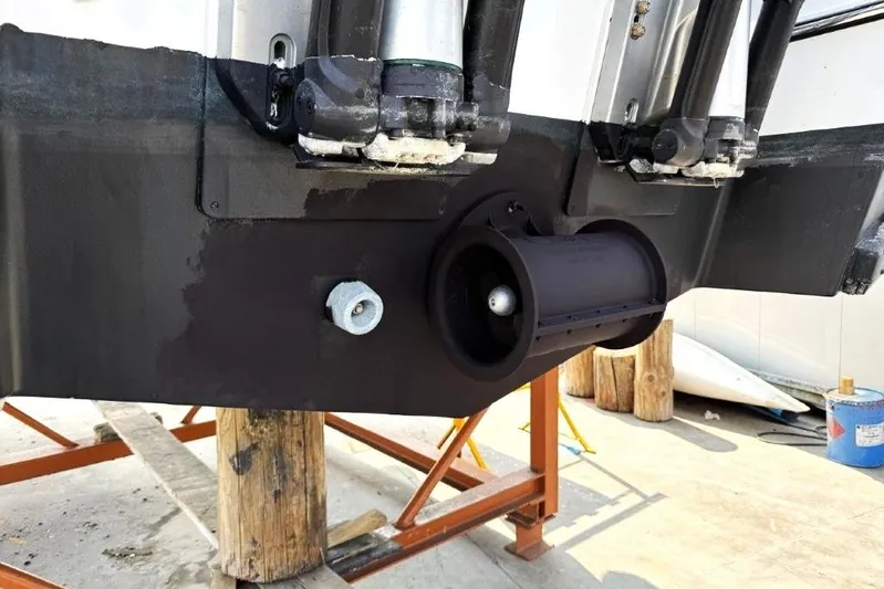  Yacht Photos Pics 2025 Jeanneau Merry Fisher 1095 boat hull detail with thruster and support stands.