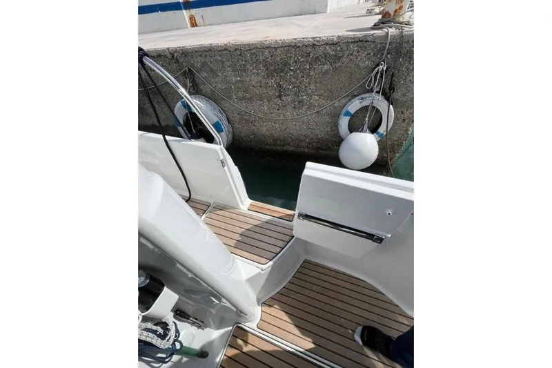  Yacht Photos Pics 2025 Jeanneau Merry Fisher 1095 boat docked, showing deck and open gate.