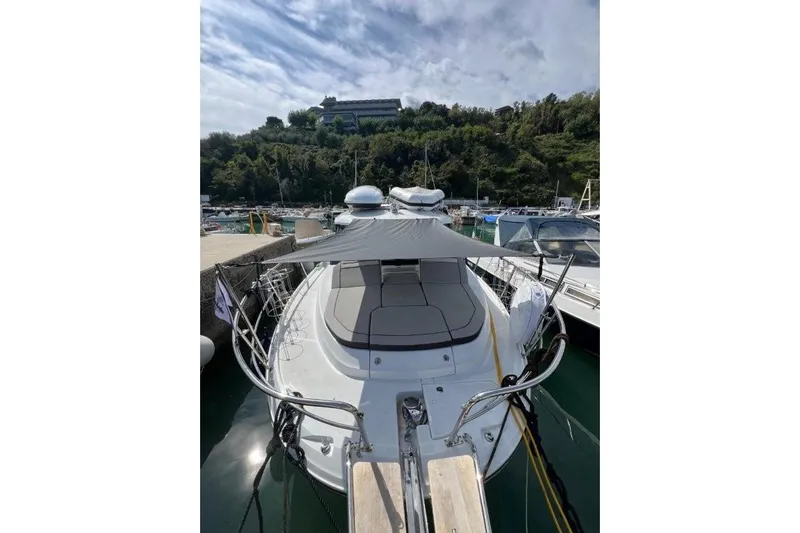 Yacht Photos Pics 2025 Jeanneau Merry Fisher 1095 docked at marina, featuring sleek design and sunshade.